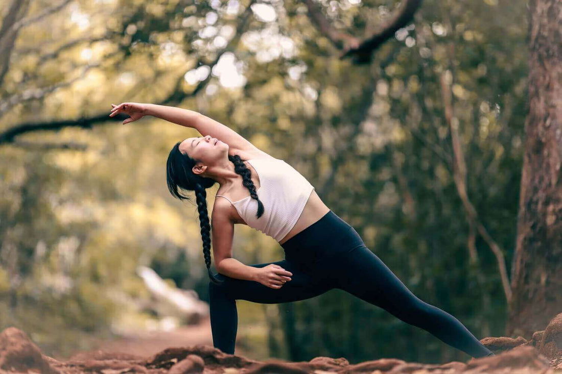 Woman stretching in nature. Discover the power of stretching in a Daily Stretch.